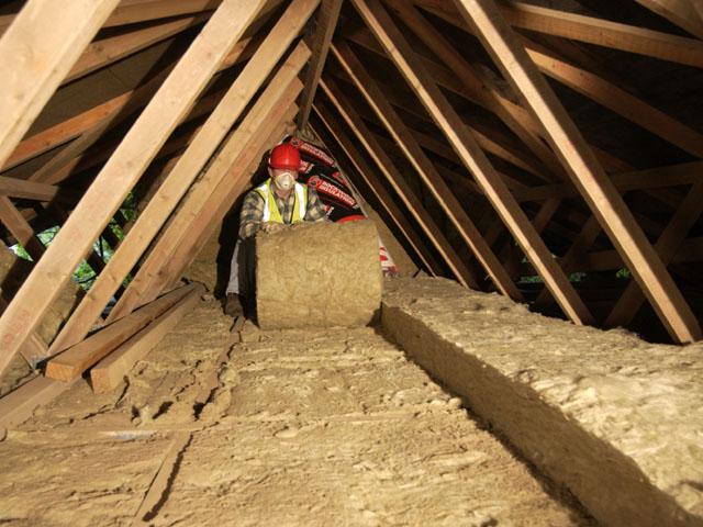 Picture of a tradesperson insulating a loft