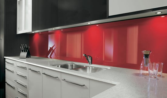 Picture of a kitchen with sink and bright red splashback