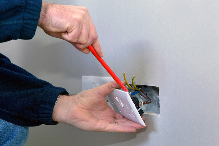 Electrician fixing a socket 