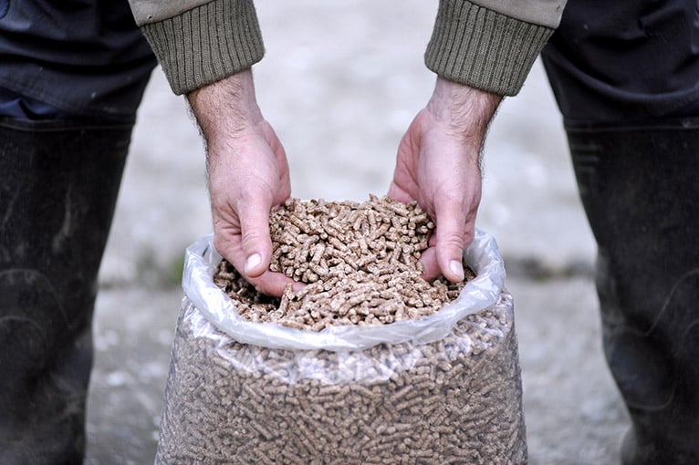 Person taking wood pellets from a bag