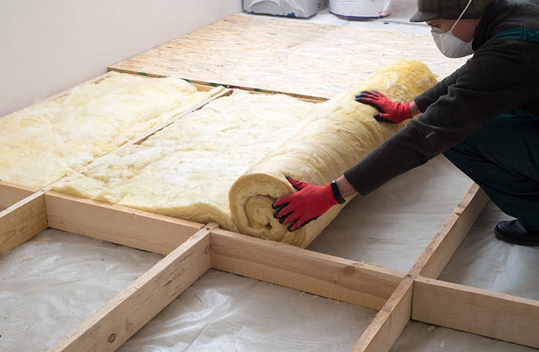 Person laying loft insulation