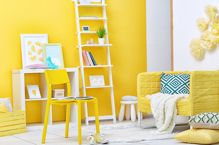 Room decorated and furnished in yellow and white