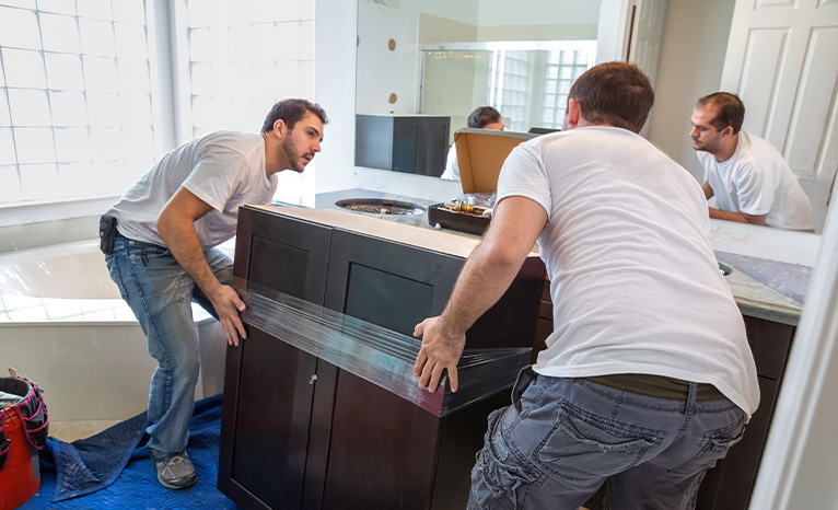 Two men moving a piece of furniture