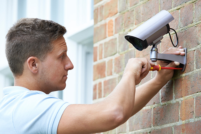 CCTV being fitted on an exterior wall