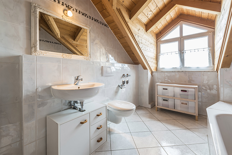 Spacious white bathroom with wooden loft ceiling