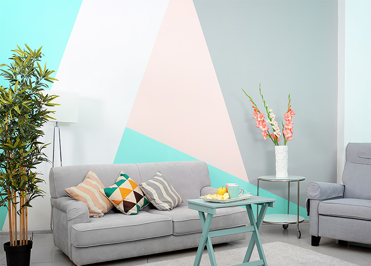 Bright blue, pink and grey geometric print feature wall