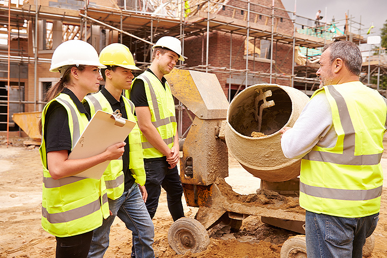 Builder and apprentices working on a housebuilding project