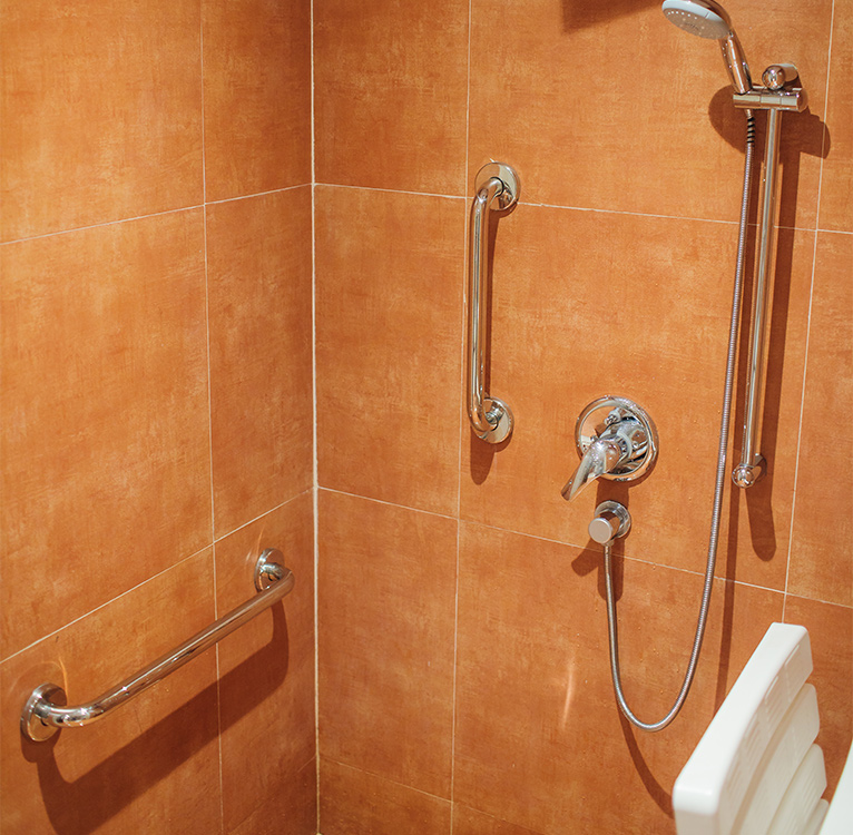 Orange shower with metal grab rails