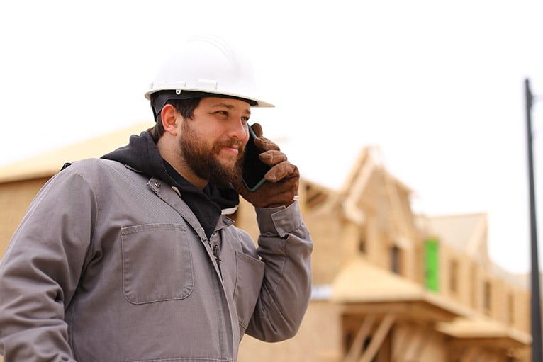 Tradesman using the phone outdoors
