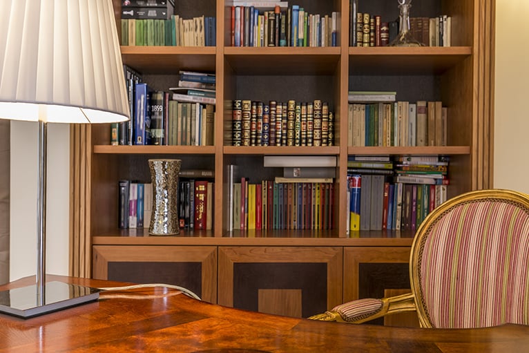 Wooden bookcase with colourful books in home office