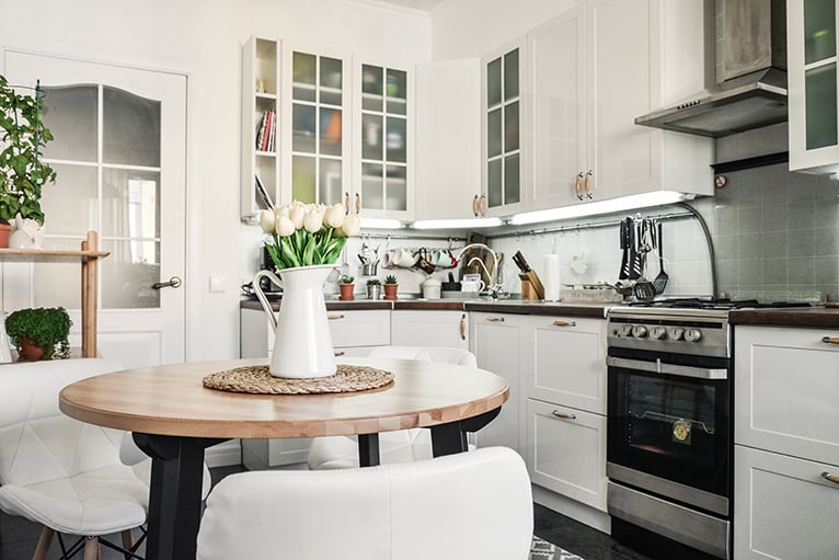 Bright white kitchen with lilies on the table