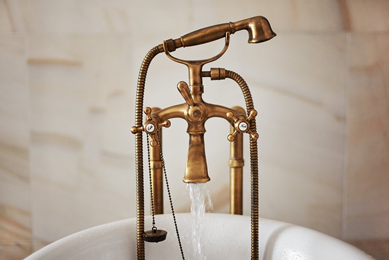 Antique bronze taps in bath