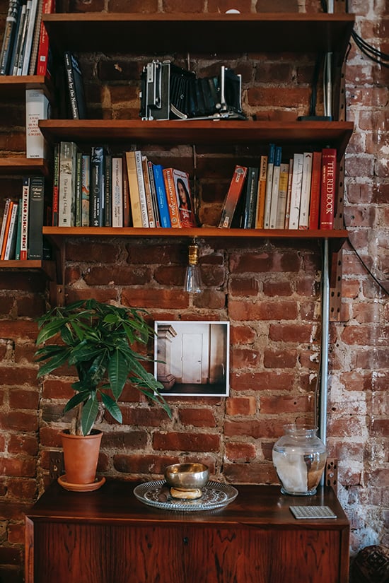 Bookshelf against exposed brick wall