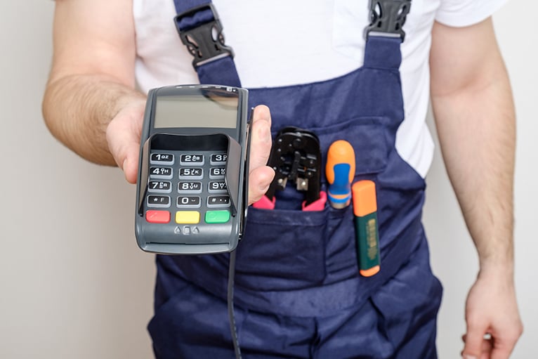 Tradesperson holding a payment terminal