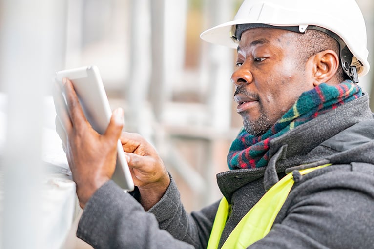 Trades technology: Tradesman using a tablet on site