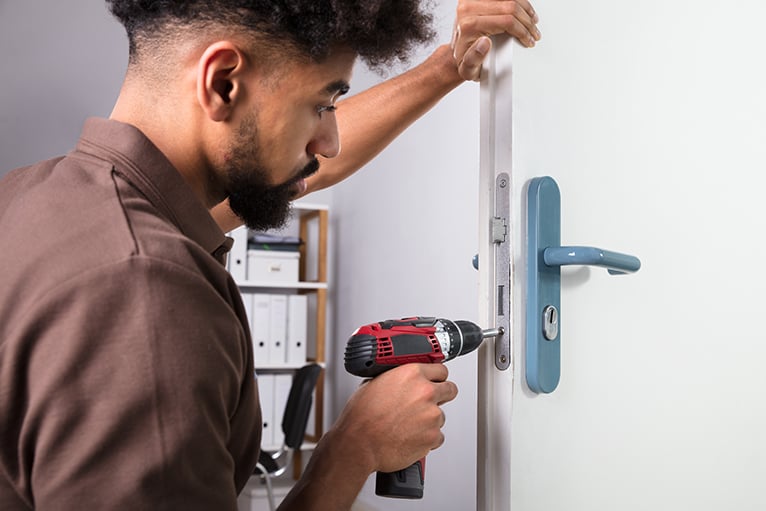 Home security: Locksmith installing a lock
