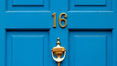 Bright blue door with the number 16 and a door knocker