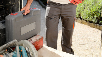 Tradesperson loading equipment into a van