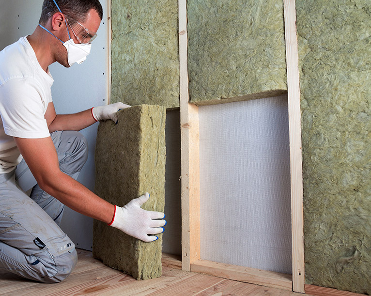 Soundproofing specialist installing soundproofing insulation