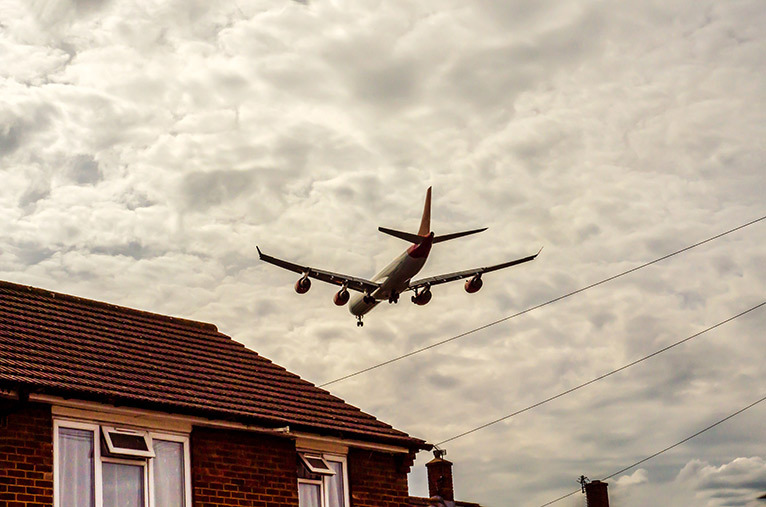 Plane flying over a home
