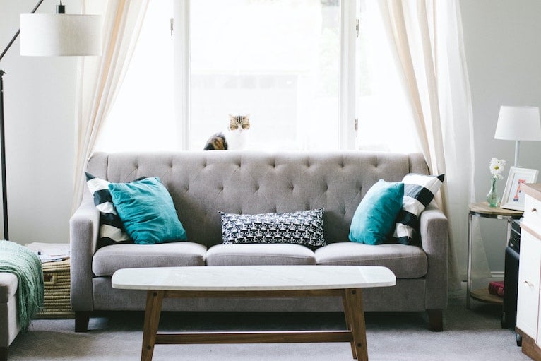 Grey fabric sofa with blue cushions
