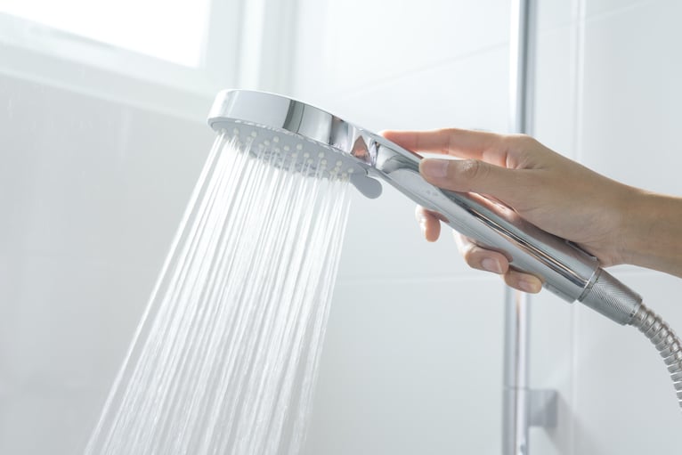 Hand holding shower head with good water pressure