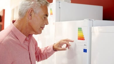 Man looking at energy label of fridge freezer