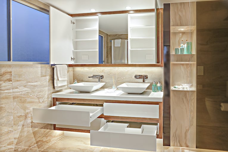 Bright bathroom with open cabinets and drawers