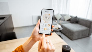 Person adjusting heating schedule on smartphone