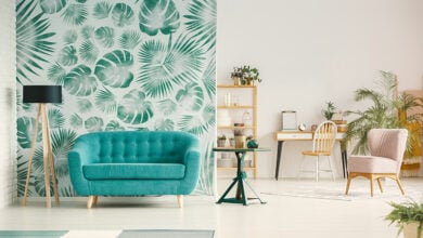 Bright living room with green foliage wallpaper feature wall