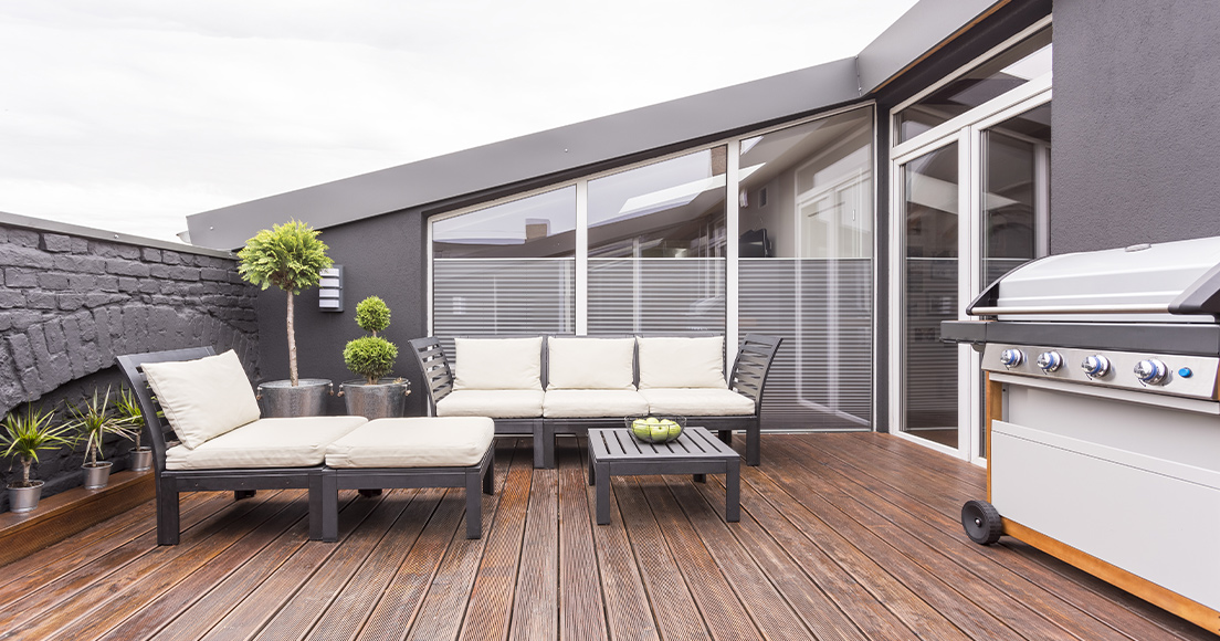 Big outdoor space with wooden decking, garden furniture and BBQ.