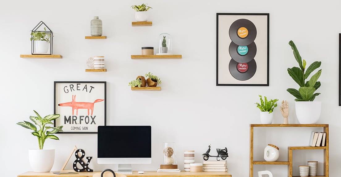 Six simple wooden shelves on the wall in a home office.