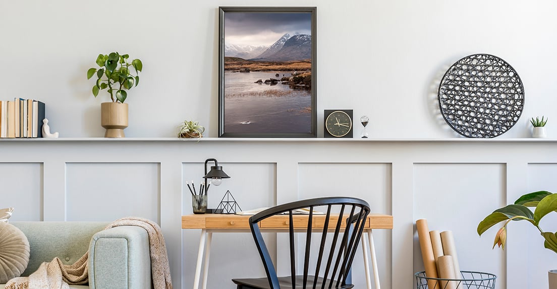 Framed print of the outdoors in a home office.