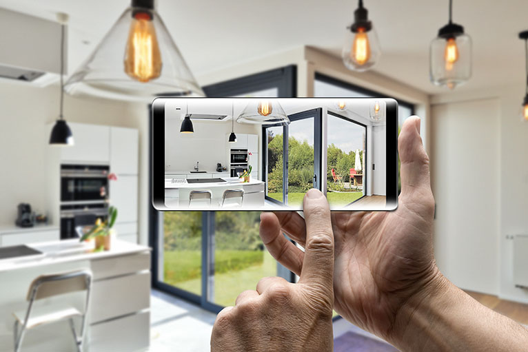 Person taking a photo of kitchen on smartphone