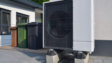 Air source heat pump in front of apartment building