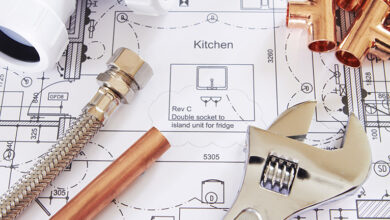 Plumbing tools on top of house plans