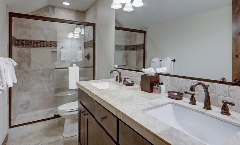 Walk-in shower in brown-themed bathroom