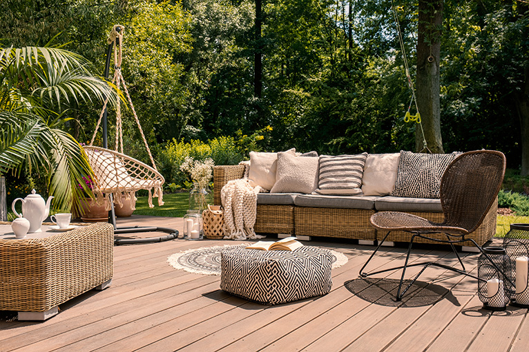 Rattan outdoor furniture set on wooden patio