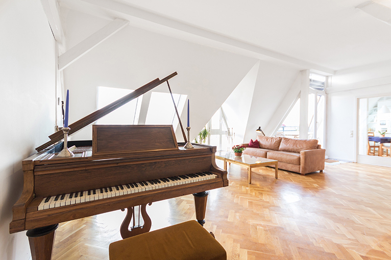 Baby grand piano in open plan room