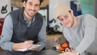 Two tradespeople smiling