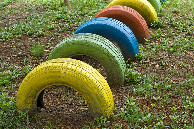 Upcycled tires in garden as children's play equipment