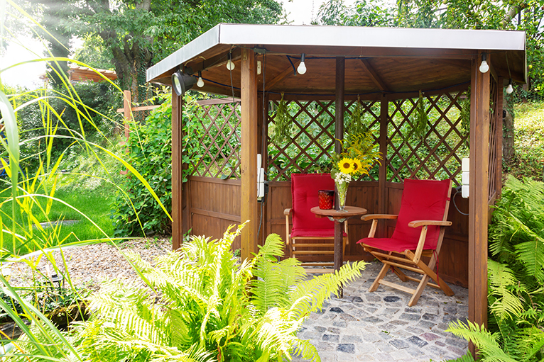 Garden pavilion with pond, sitting area and trellis, in all year round garden