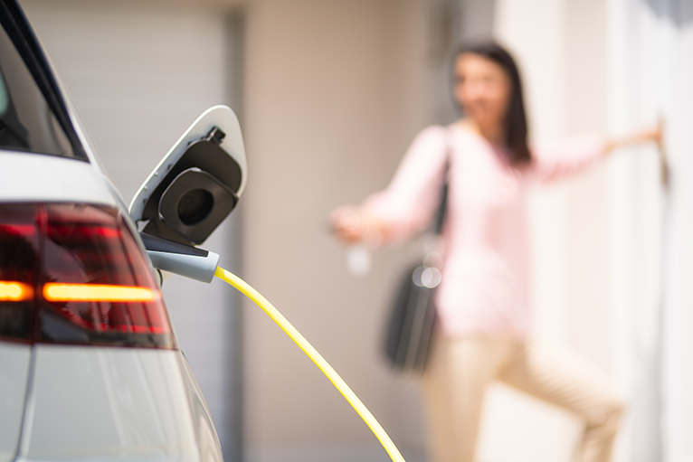 Homeowner charging electric car.