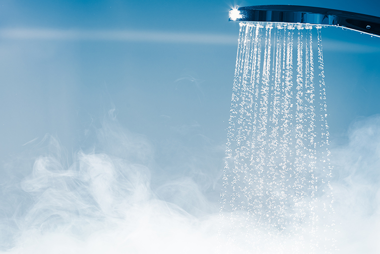 Water efficient home: Running shower with steam rising