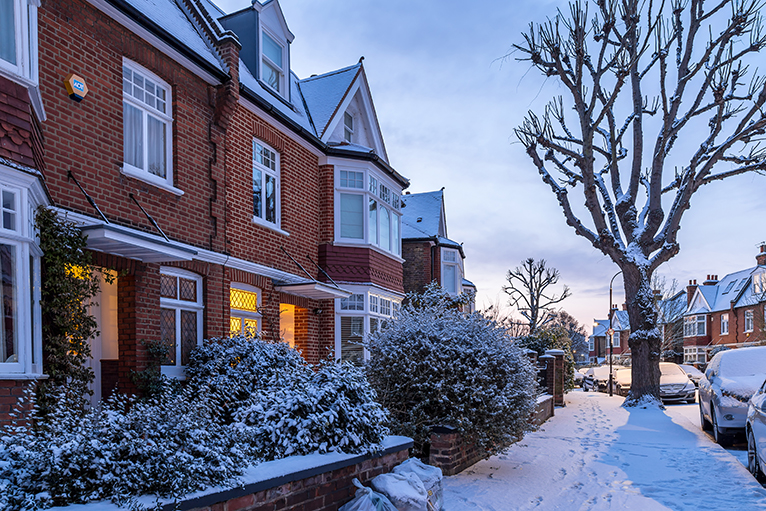 Snow covered terraced houses in London, UK