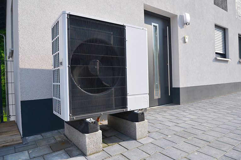 Energy efficiency home grants: Air to air heat pump in front of building