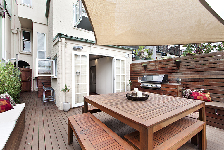 Wooden patio area with built-in BBQ