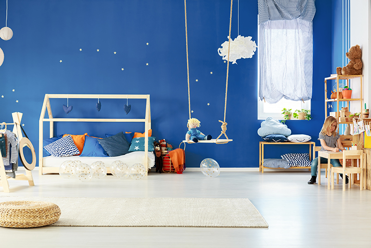 Childrens bedroom with swing and wooden furniture