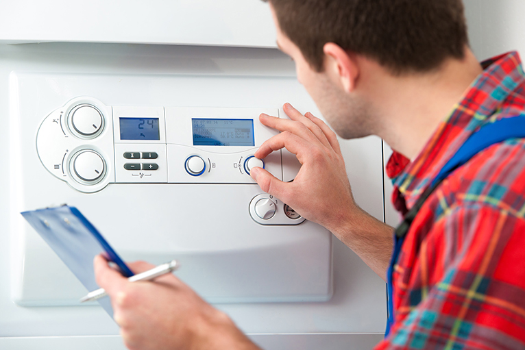 Summer home improvement job ideas: Gas and heating engineer servicing boiler