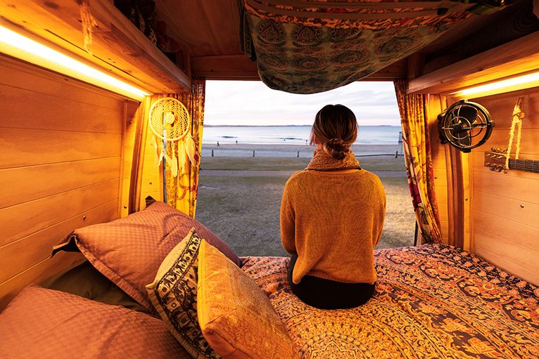 Person watching sunset from campervan